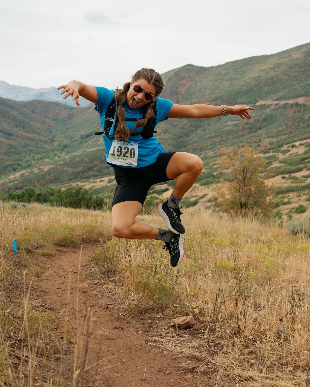 A runner leaping off the trail mid stride.