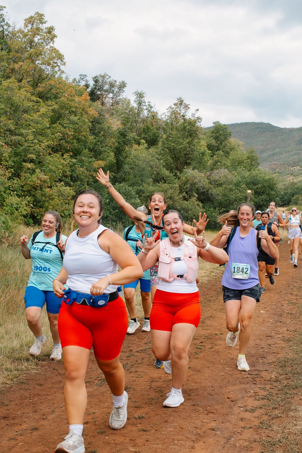 A pack of runners climbing the trail together.