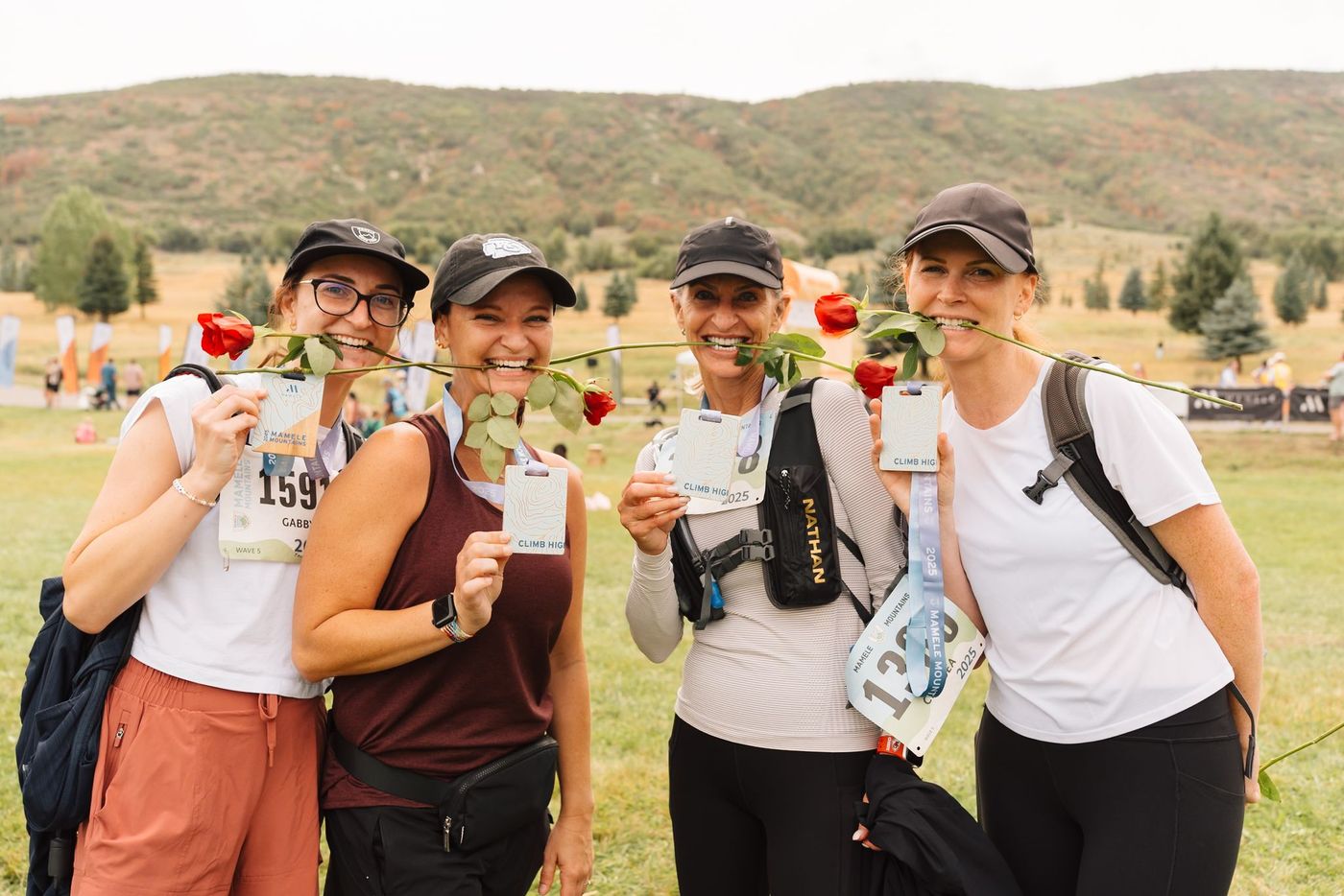 Four women holding roses after the race.
