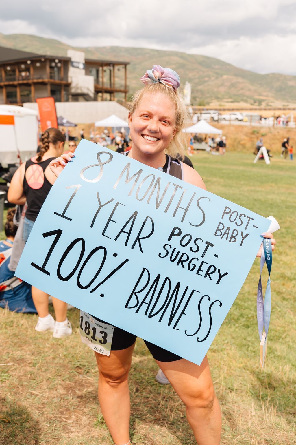 A racer holding a handmade sign on the course.